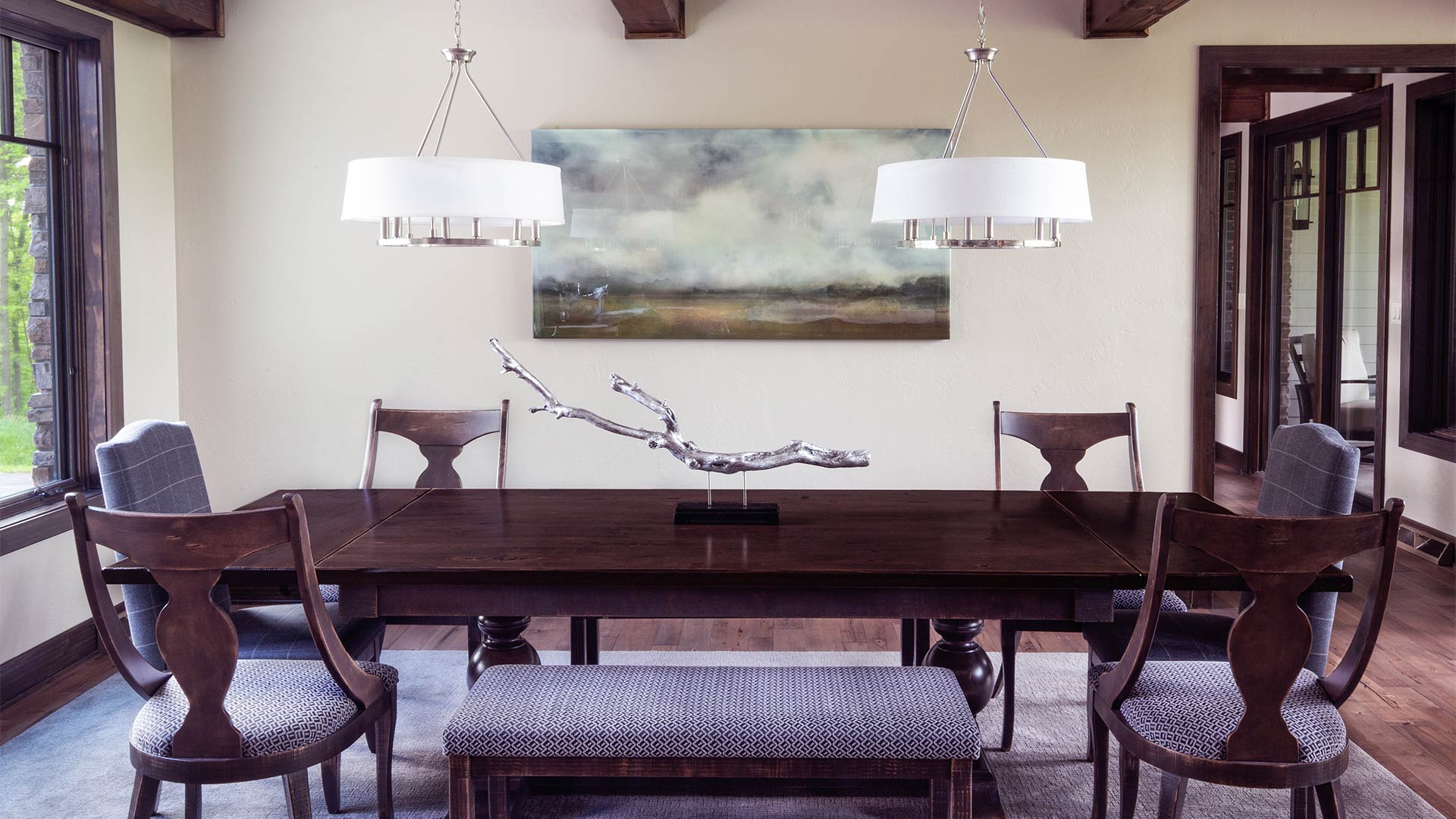 an interior shot of the dogwood dining room. there is a long wooden table in the center of the room with wooden chairs around it.