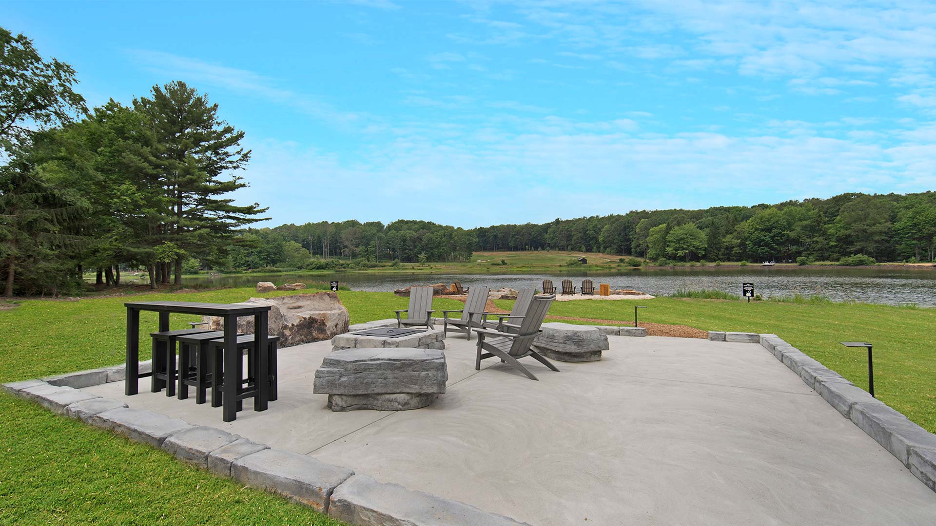 an exterior shot of the lake and the sitting area next to it