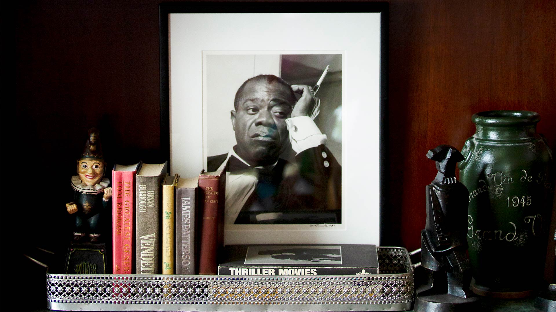 a picture frame and books inside a study