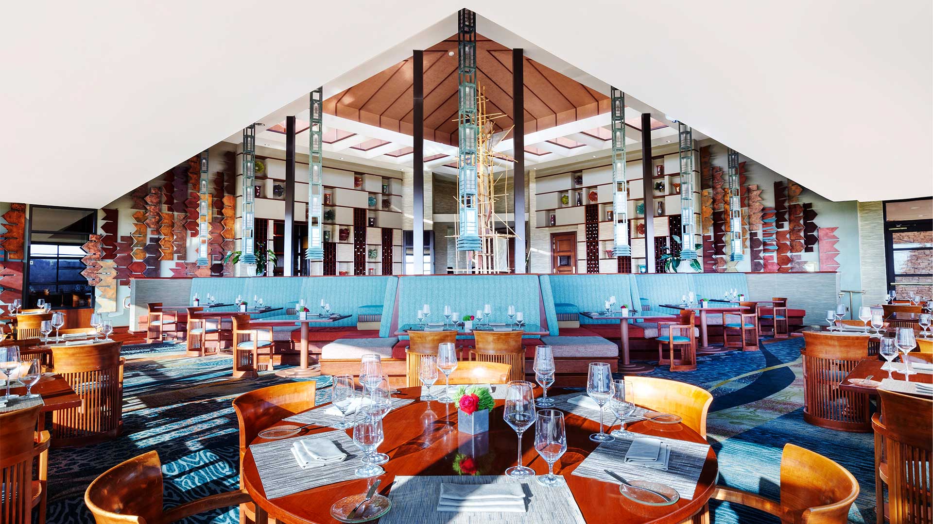 restaurant with blue booth seating and a modern open interior design