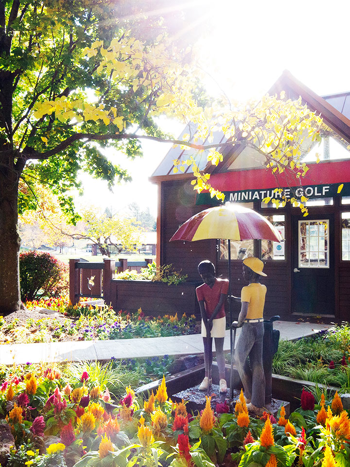 two people playing miniature golf