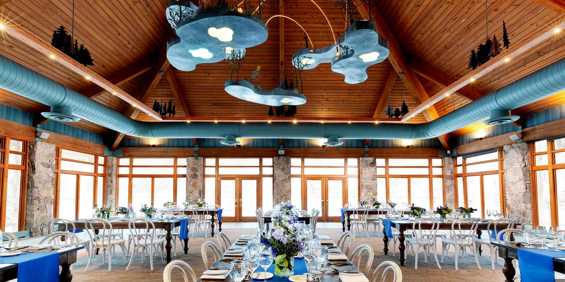 large dining room with wooden ceiling and large windows