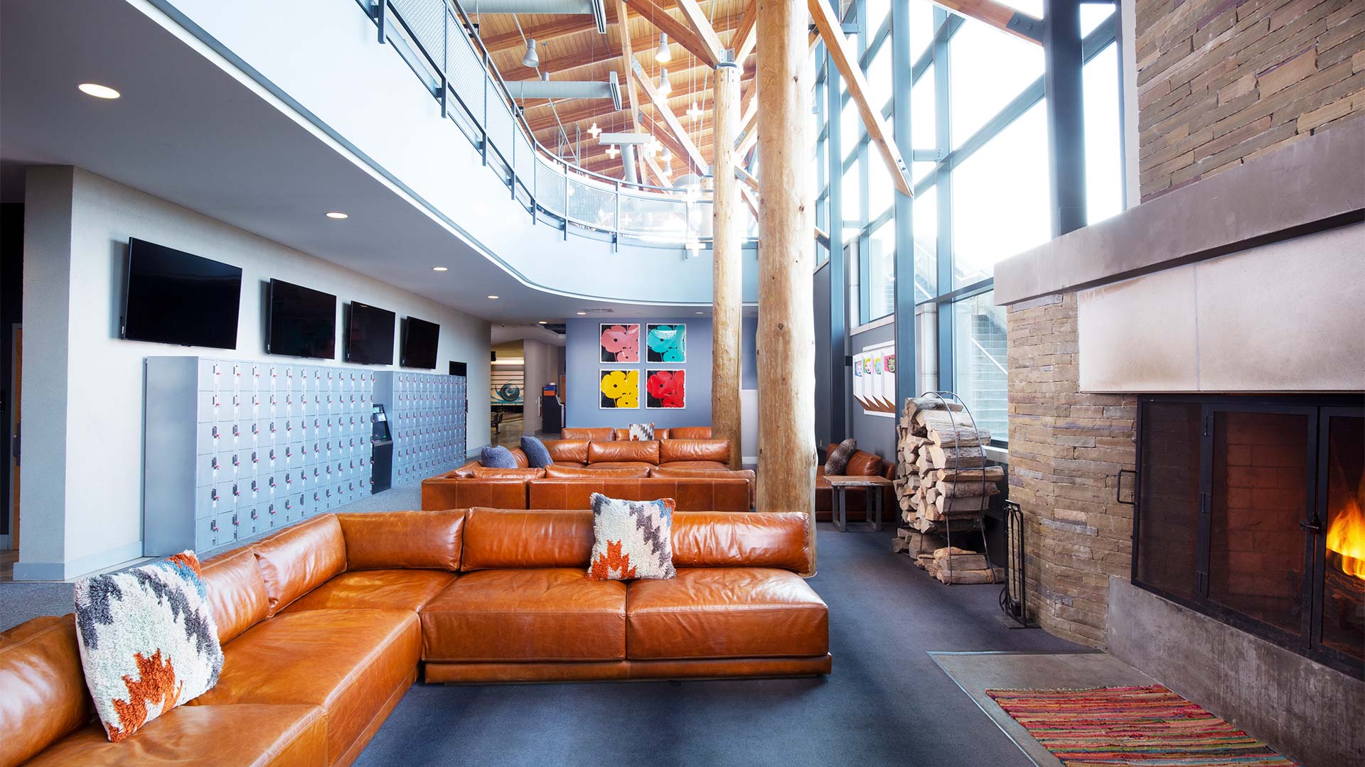 Brown leather seats infront of a fireplace.