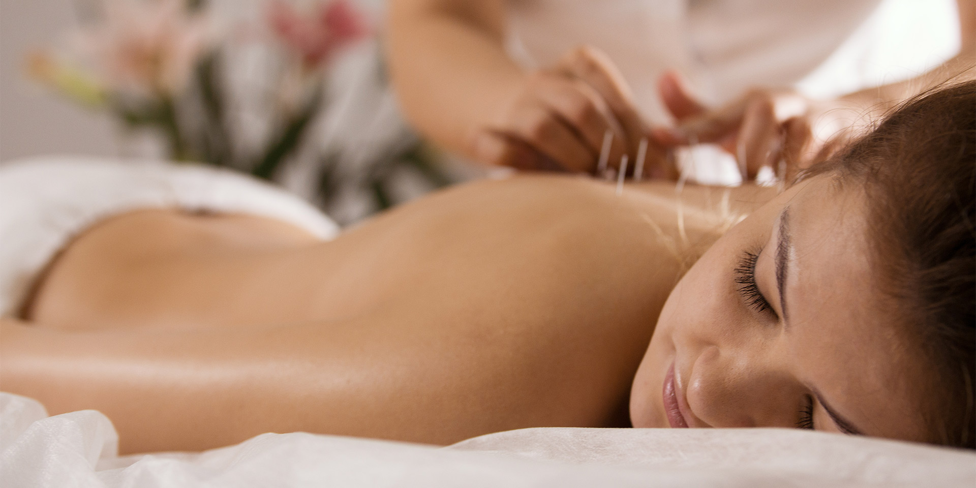 a woman enjoying an acupuncture spa session.
