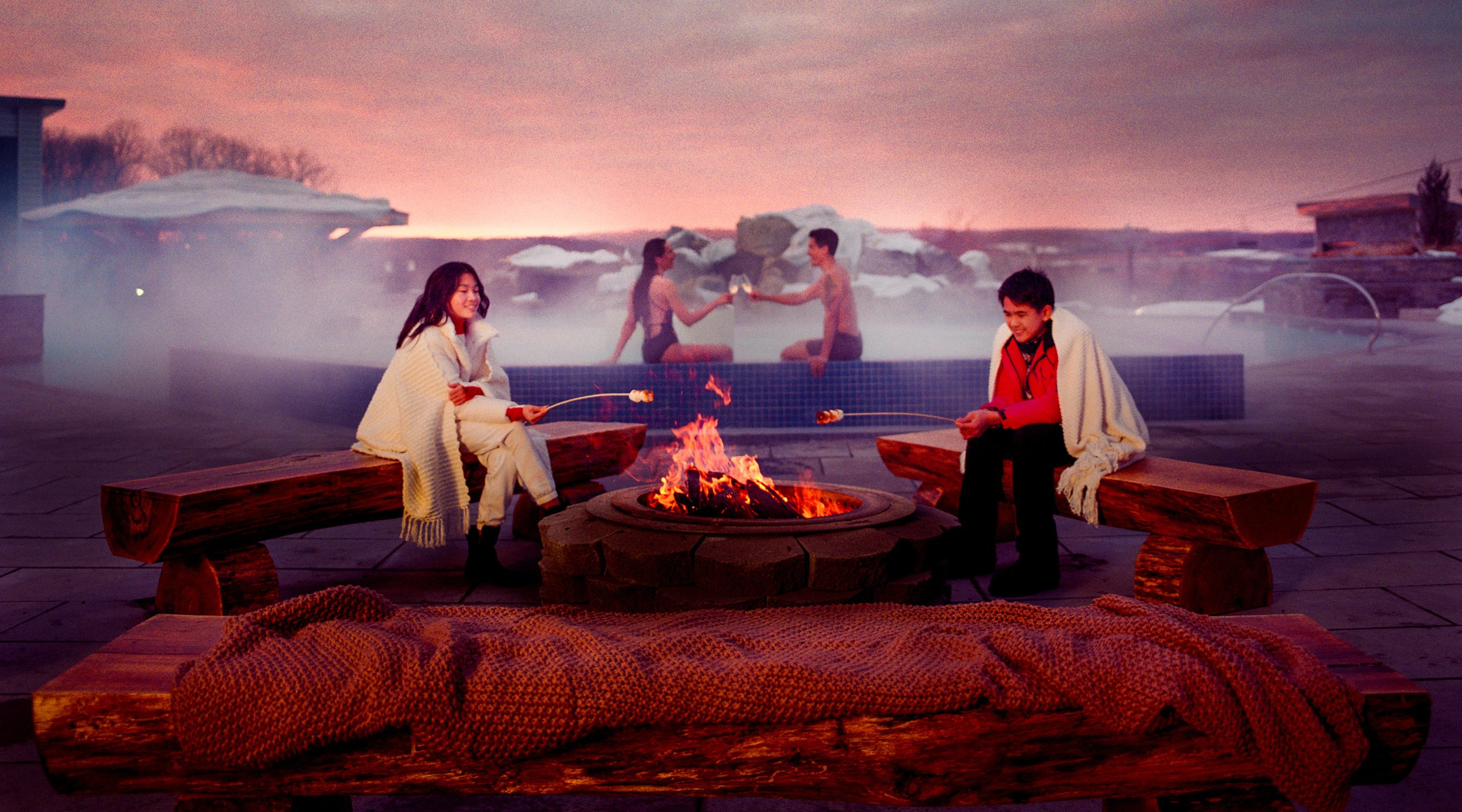 People toasting marshmallows Fit pit by a heated pool