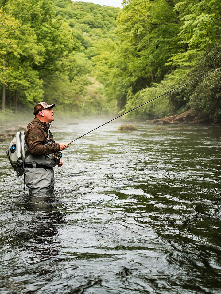 fisherman in a stream