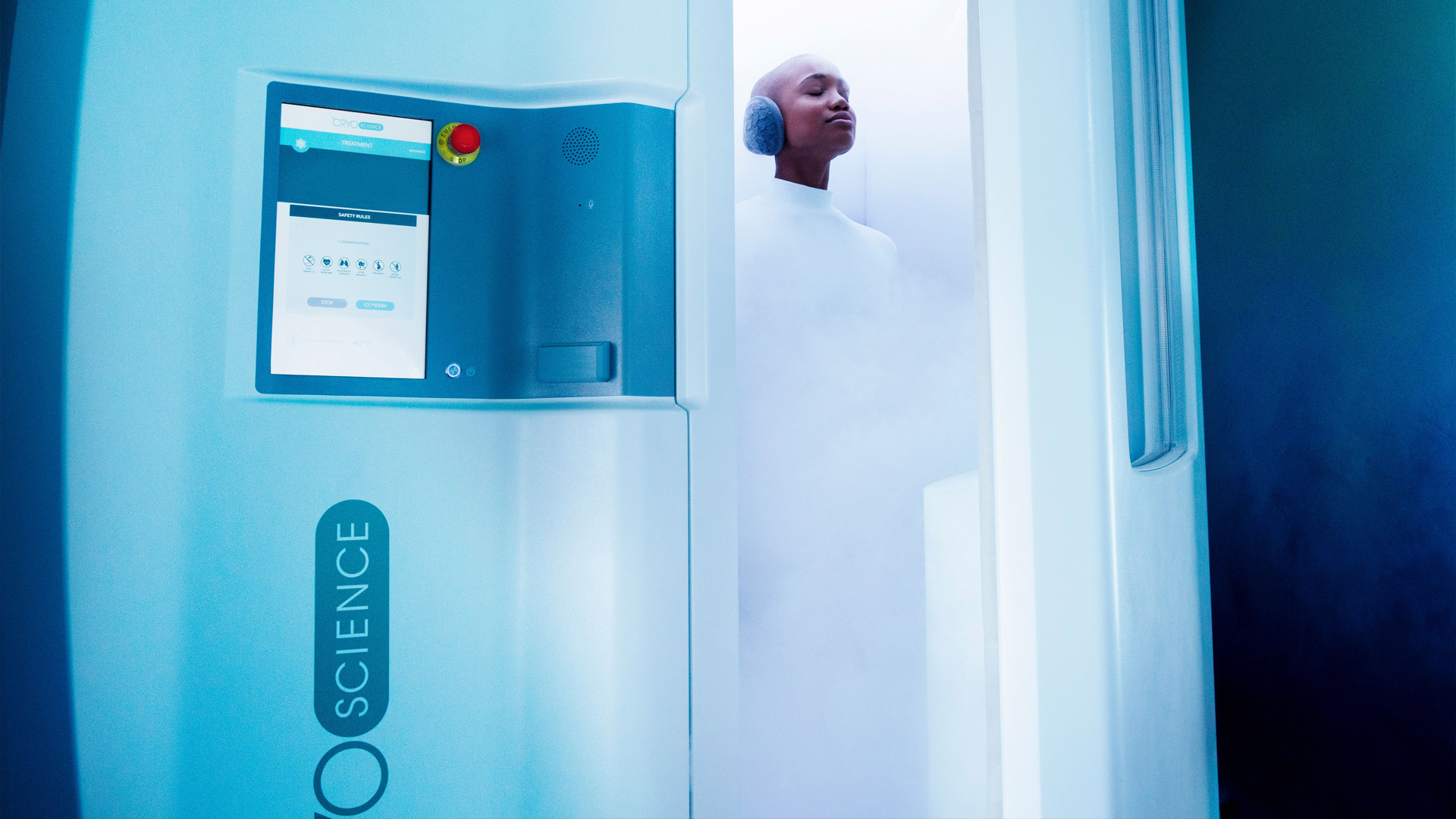 Woman inside of cryo chamber receiving cryo therapy.
