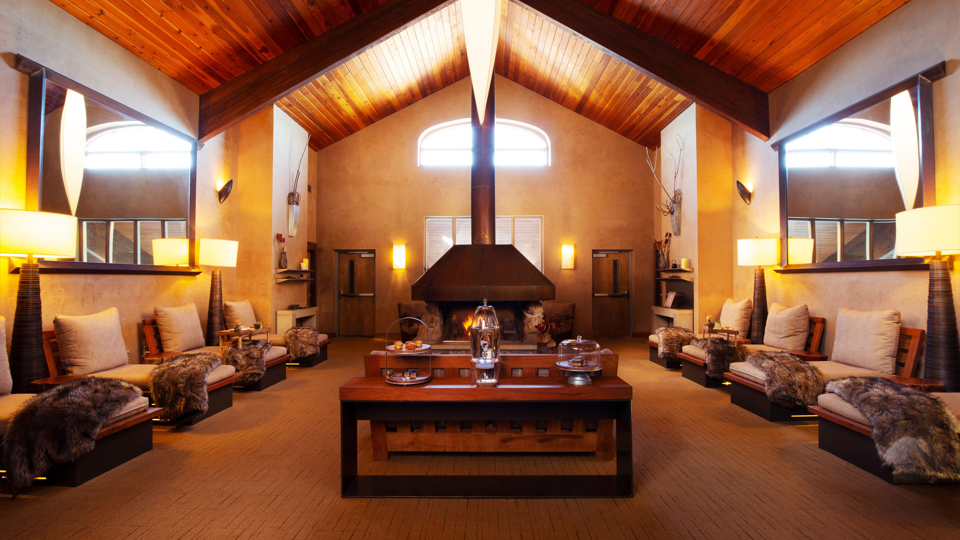 Interior view of fireside lounge with soft wood paneling and lighting.