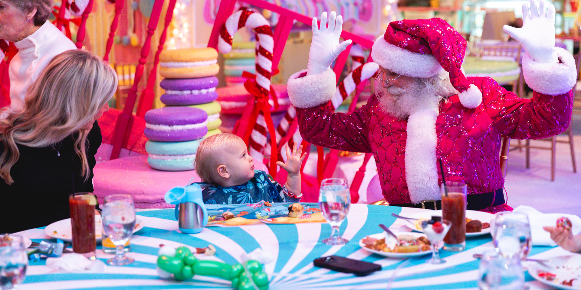 Santa in a Christmas village with a small child