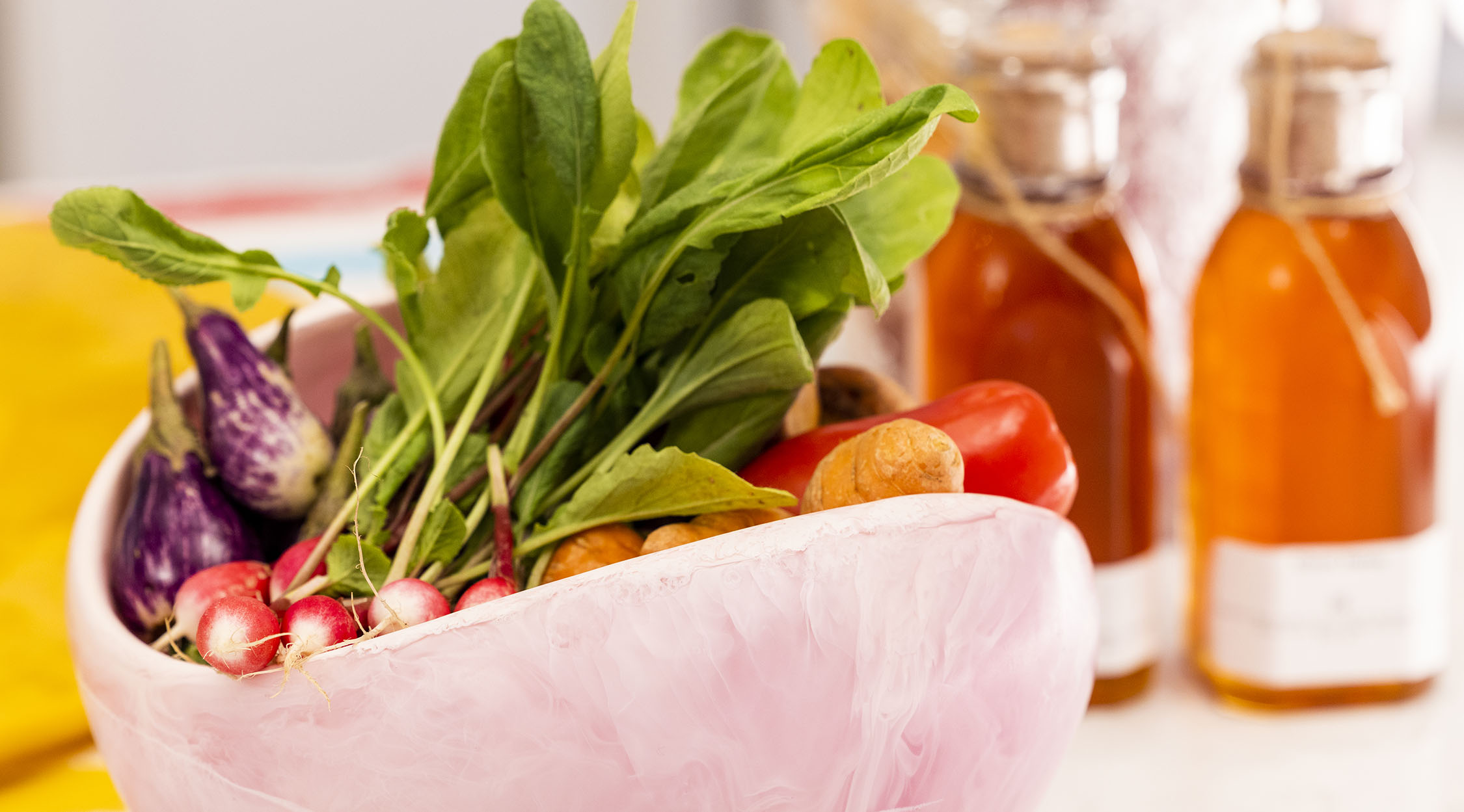 Mixed vegetables, radishes, and radicchio in a white bowl.